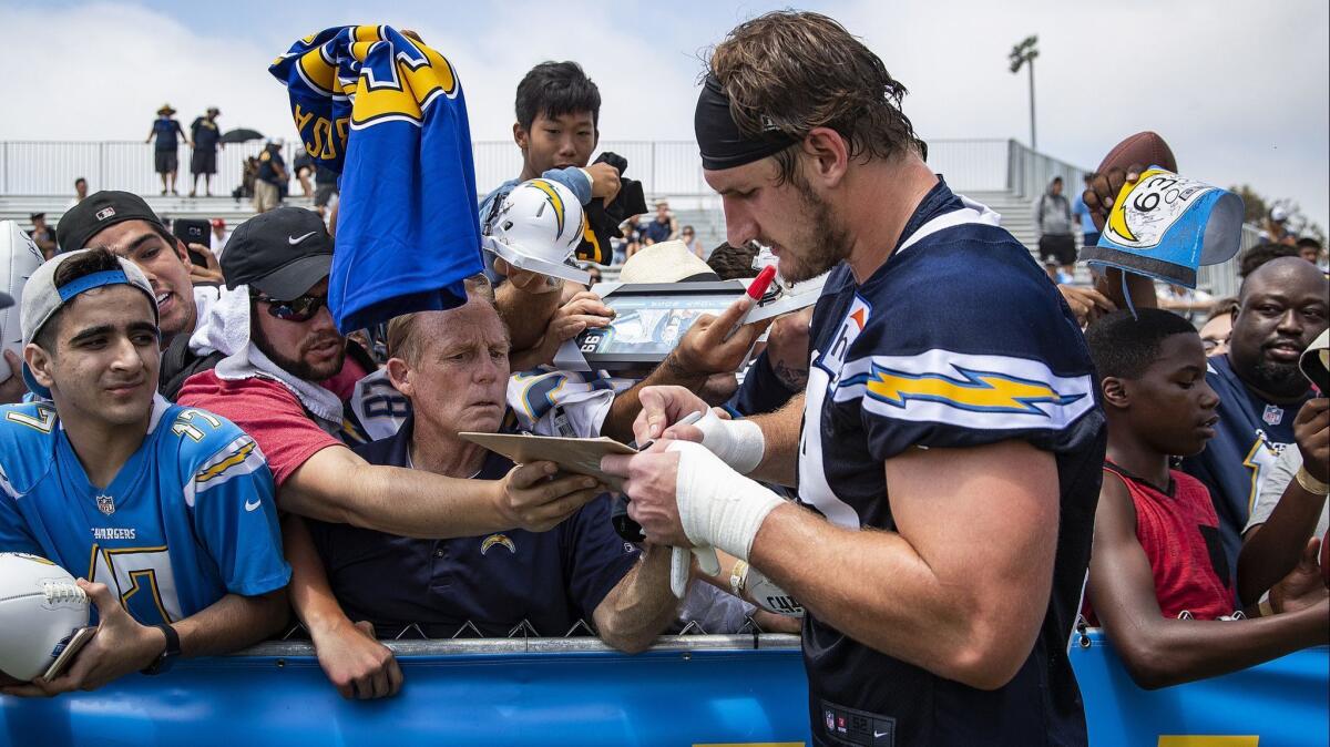 Chargers defensive end Joey Bosa signs autographs after training camp at the Jack Hammett Sports Complex in Costa Mesa.