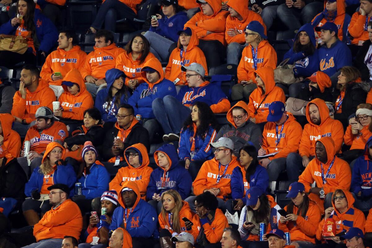 New York Mets fan watch their team take on the Kansas City Royals during Game 2 of the World Series at Kauffman Stadium in Kansas City, Mo.