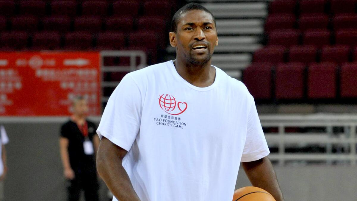 Metta World Peace joins other Lakers during a preseason event in Beijing on June 30, 2013.