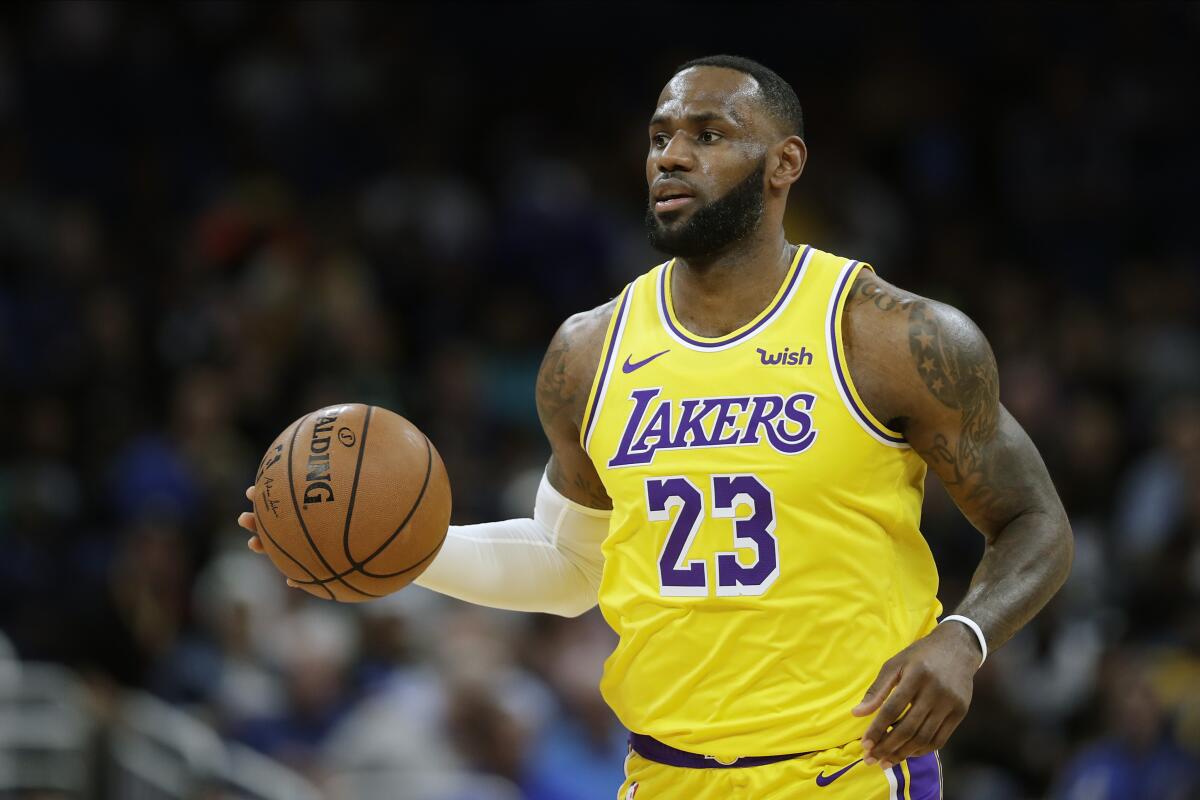Los Angeles Lakers forward LeBron James (23) moves the ball against the Orlando Magic during the first half of an NBA basketball game, Wednesday, Dec. 11, 2019, in Orlando, Fla. (AP Photo/John Raoux)