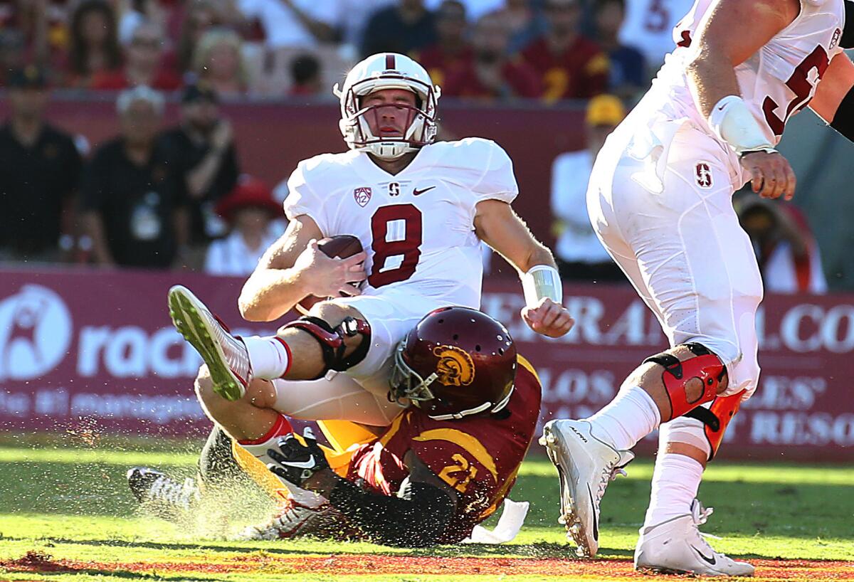 Stanford quarterback Kevin Hogan (8) sacked by USC linebacker Su'a Cravens in the first half.