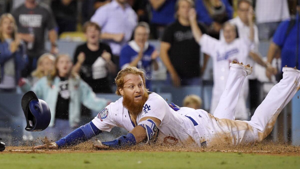 The Dodgers' Justin Turner scores in a game against the San Francisco Giants. Some TV executives point to Time Warner's purchase of Dodger broadcast rights as a prime example of sports programming costs spiraling out of control.