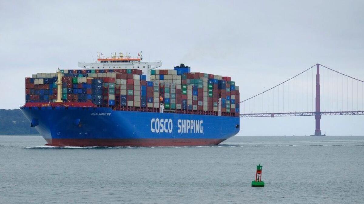 A container vessel owned by a Chinese shipping company passes the Golden Gate Bridge on May 14, bound for the Port of Oakland.