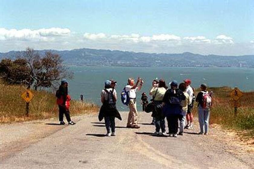 Docent Jim Leuker, center, explains some of the areas geography to a group during a nature walk in scenic Angel Island State Park.