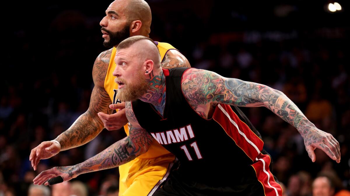 Lakers forward Carlos Boozer, top, and Miami Heat forward Chris Andersen battle for position during the Lakers' 78-75 loss at Staples Center on Jan. 13.