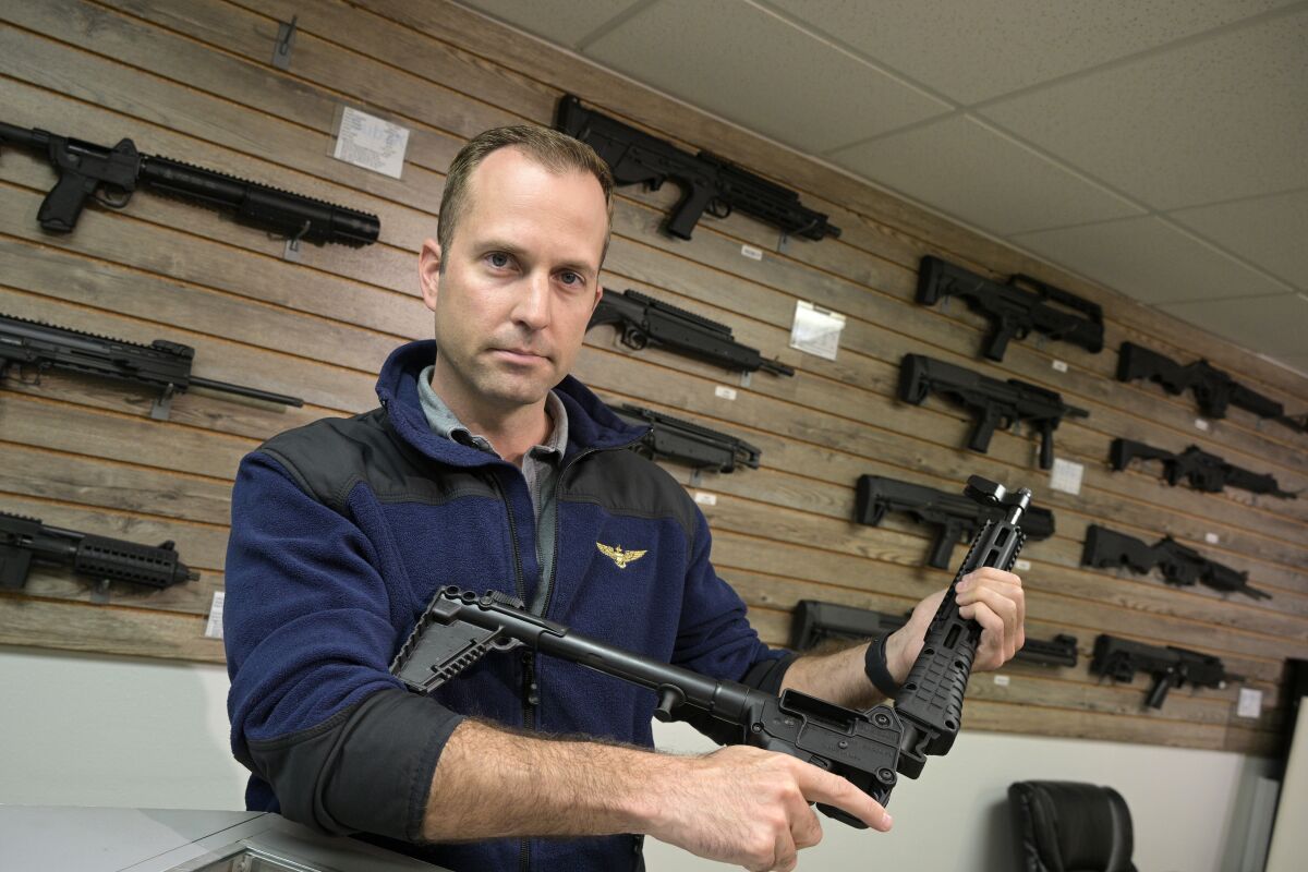 Adrian Kellgren, director of industrial production of KelTec, holds a 9mm SUB2000 rifle