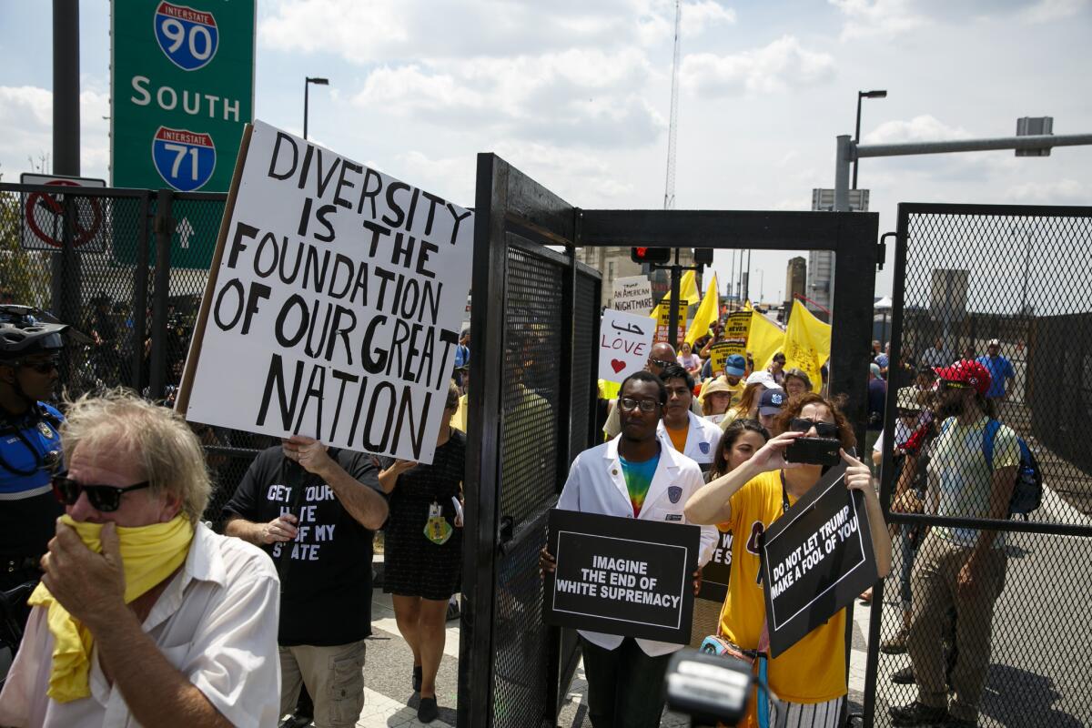 Protesters from the Stand Together Against Trump March walk within shouting distance of the Quicken Loans arena during the 2016 Republican National Convention in Cleveland.