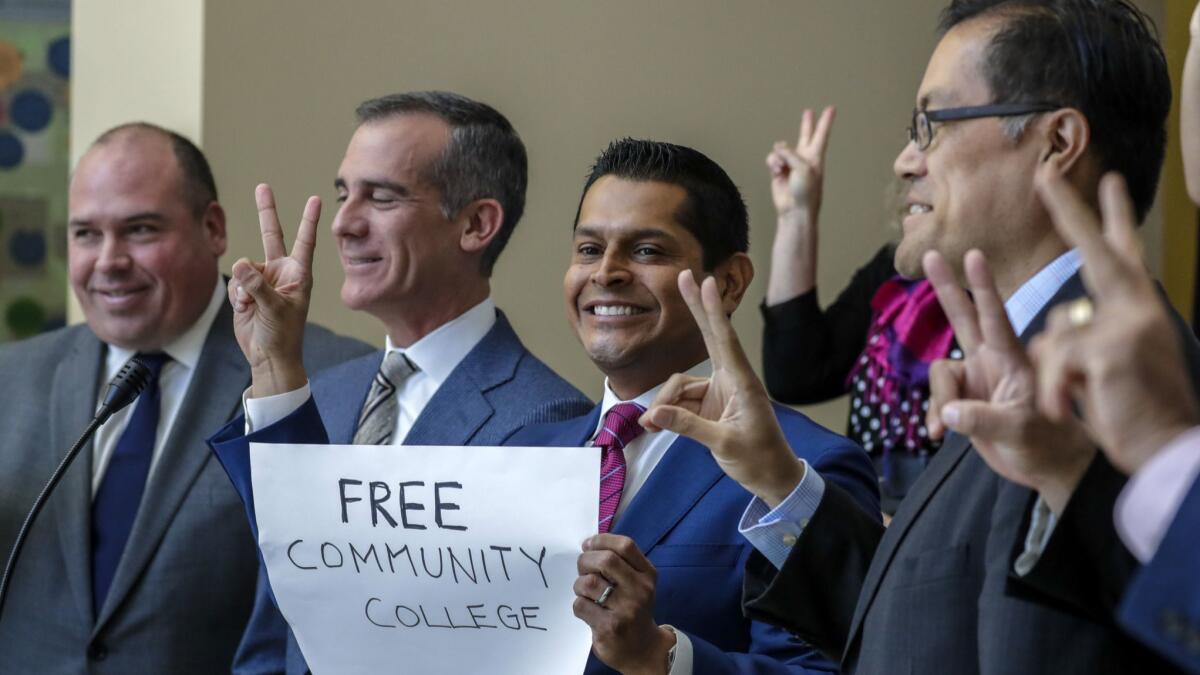 Assemblyman Miguel Santiago, holding sign, is a proponent of AB-2 that gives two years of tuition-free community college.