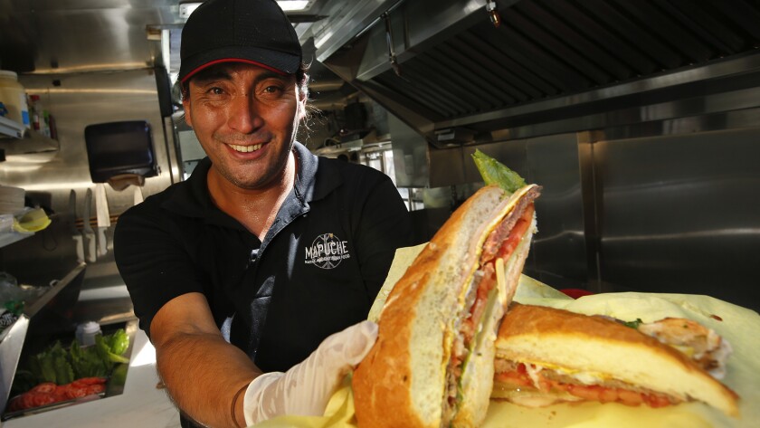 Carlos Leiva, chef and owner of the Mapuche Native Argentinian Food truck, with a lomito sandwich.