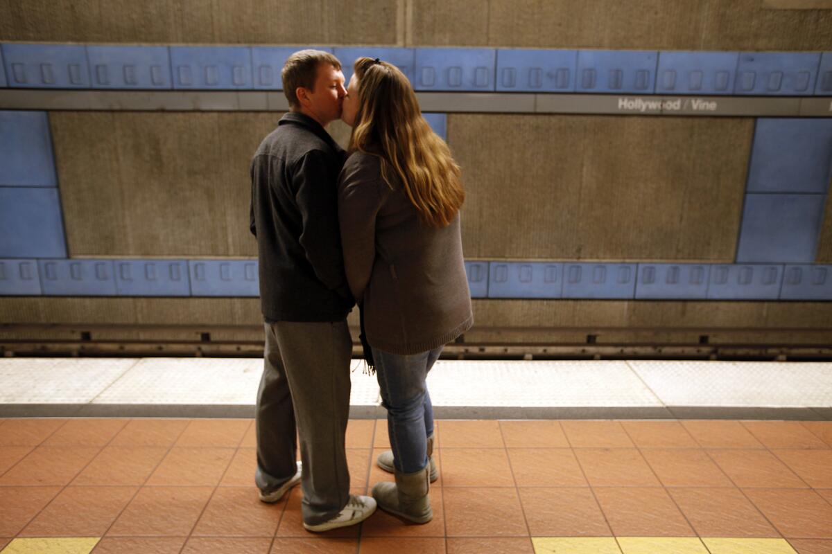 Joe Rodearmel and Denise Philpott kiss in 2011 on the platform at Hollywood and Vine while waiting for a Metro Red Line train.