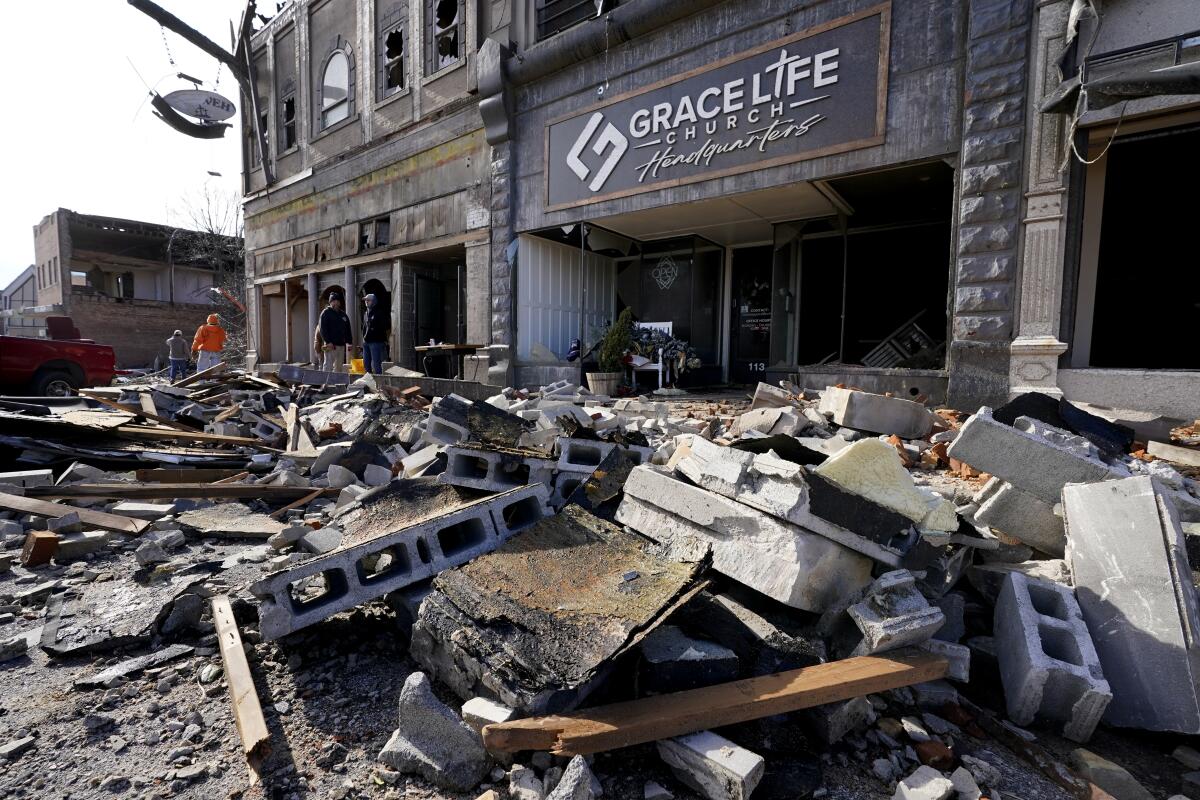 Rubble fills a downtown street near businesses and a church