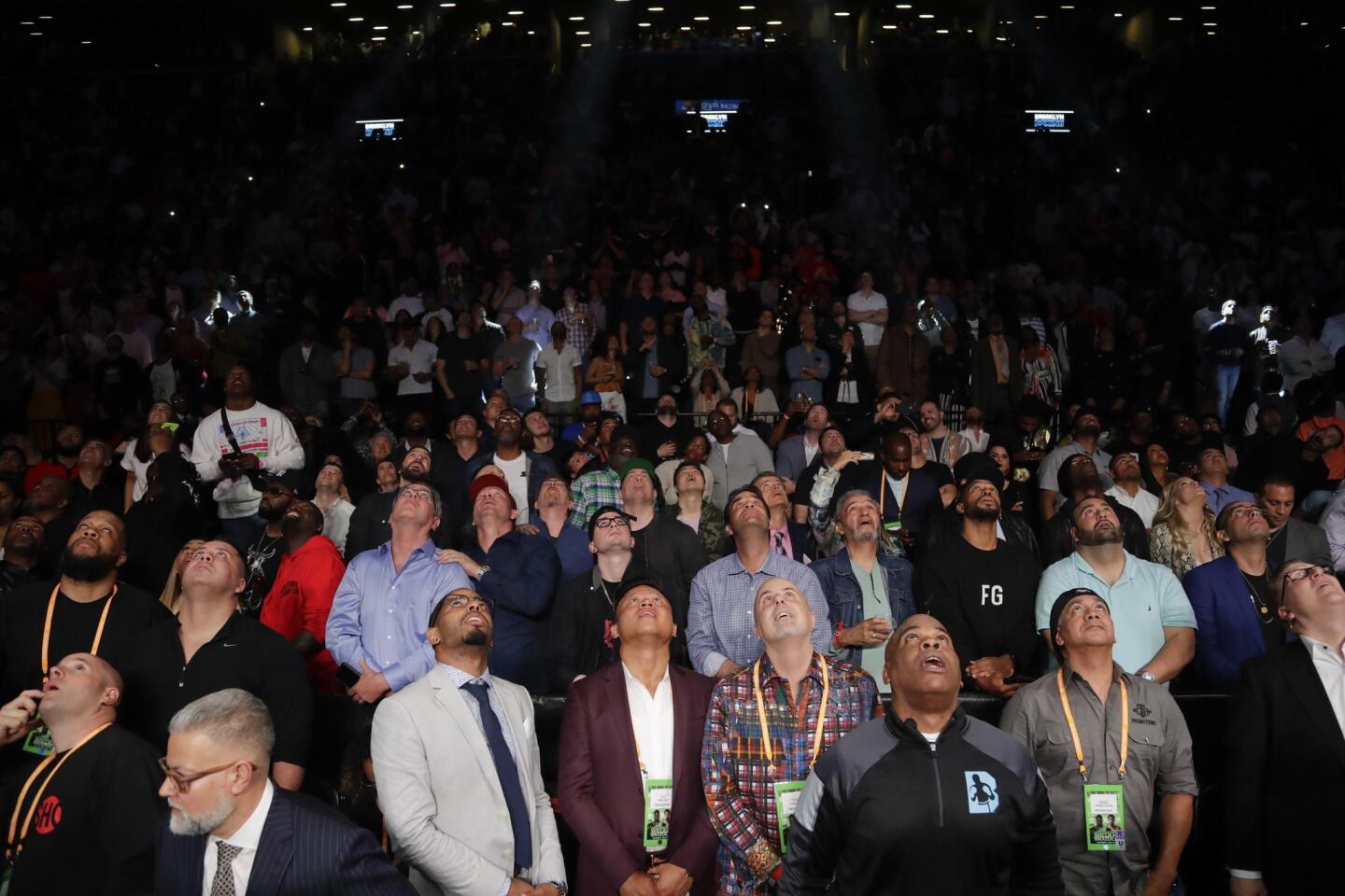 Fans watch the replay of the WBC heavyweight championship boxing match between Dominic Breazeale and Deontay Wilder on Saturday, May 18, 2019, in New York. Wilder won in the first round.