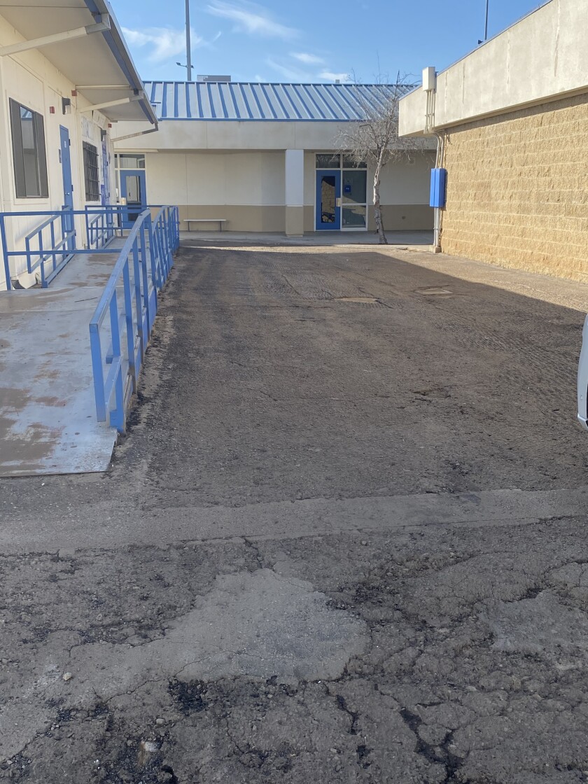 A shot of the broken asphalt and gravel at Ramona High before a resurfacing project.