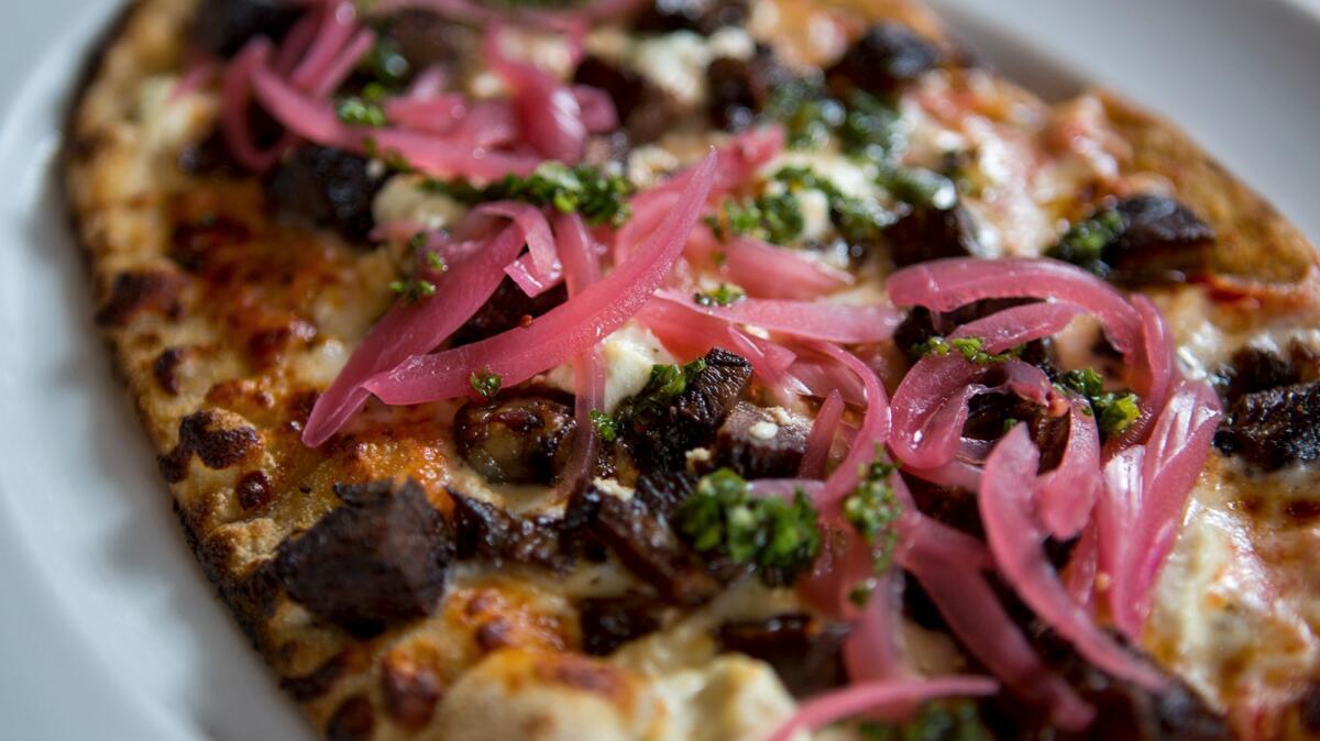 Short rib pizza with pickled red onions, marinara, chimichurri and goat cheese from the Pelican Grill at the Resort at Pelican Hill on Wednesday, June 21.