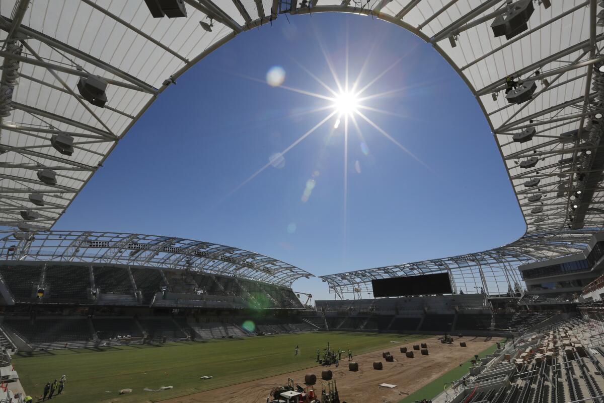 Construction workers put in new grass of Los Angeles Football Club's new Banc of California stadium in February.