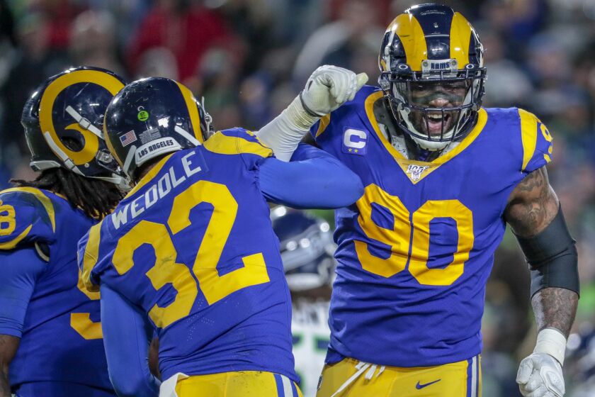 LOS ANGELES, CA, SUNDAY, DECEMBER 8, 2019 - Los Angeles Rams free safety Eric Weddle (32) and defensive end Michael Brockers (90) celebrate after stopping a Seahawks drive late in the game at LA Memorial Coliseum. (Robert Gauthier/Los Angeles Times)