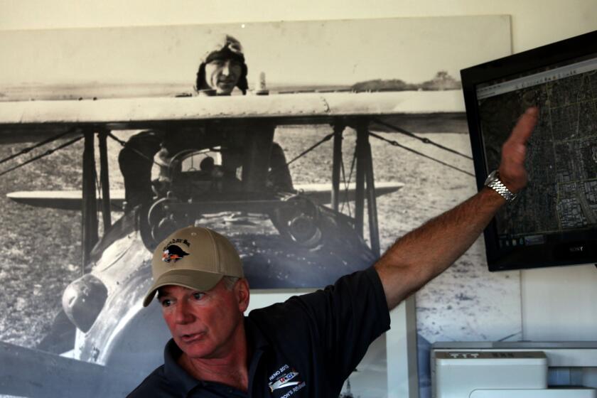 VAN NUYS, CA-DECEMBER 15, 2013: The Condor Squadron flies North American AT-6 WWII era planes out of Van Nuys airport. Chris Rushing goes over the flight plan during a briefing prior to their flyover of the Chatsworth parade and Malibu. (Michael Robinson Chavez/Los Angeles Times)