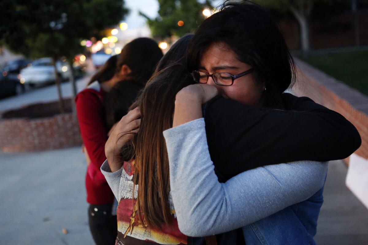 Leighla Carbajal, 12, left, and Vanessa Luna, 13, hug at a candlelight vigil at Eastmont Intermediate School. The vigil was held for Angela Sandoval, who was one of five people killed Saturday morning in a Nevada crash.