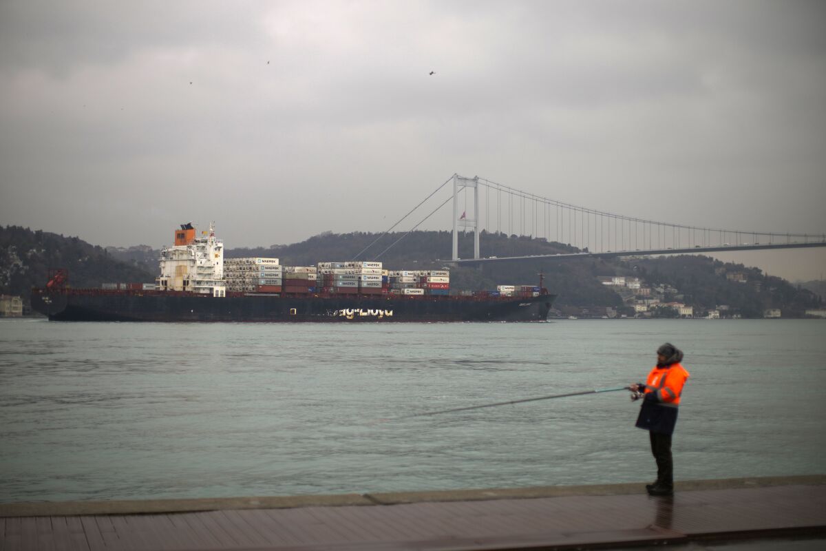 FILE - Cargo ship Oakland crosses the Bosphorus strait towards the Marmara sea after departing from Russia's Novorossiysk port, in Istanbul, Tuesday, March 1, 2022. Turkey, which is trying to balance its support for Ukraine with its fragile economic ties to Russia, said Monday it is implementing an international convention that allows the country to shut down the straits at the entrance of the Black Sea to warships, to avoid an escalation of the conflict. (AP Photo/Francisco Seco, File)