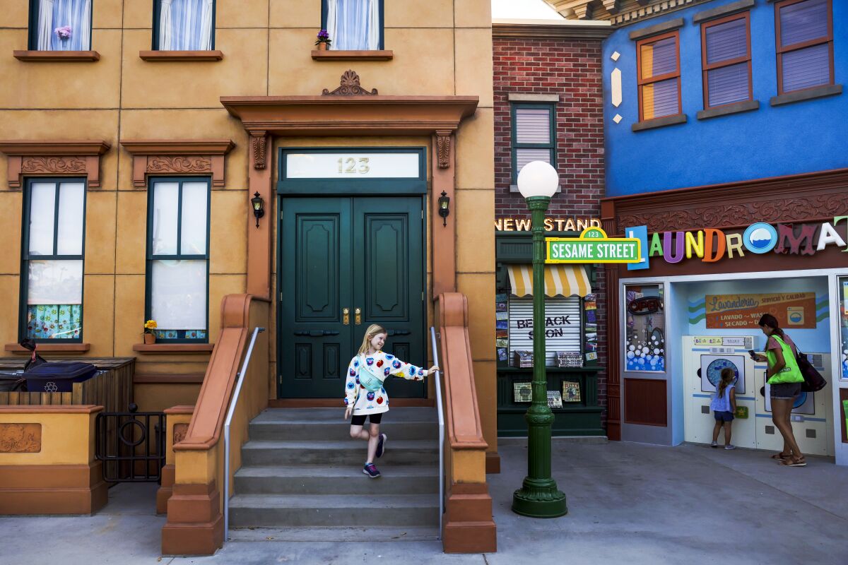 A girl stands at the 123 Sesame Street Stoop at Sesame Place
