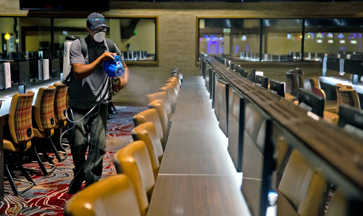 A Sycuan casino employee disinfects the interior of the casino. The casino is one several in San Diego that are planning to reopen. (Courtesy of the Sycuan Casino)