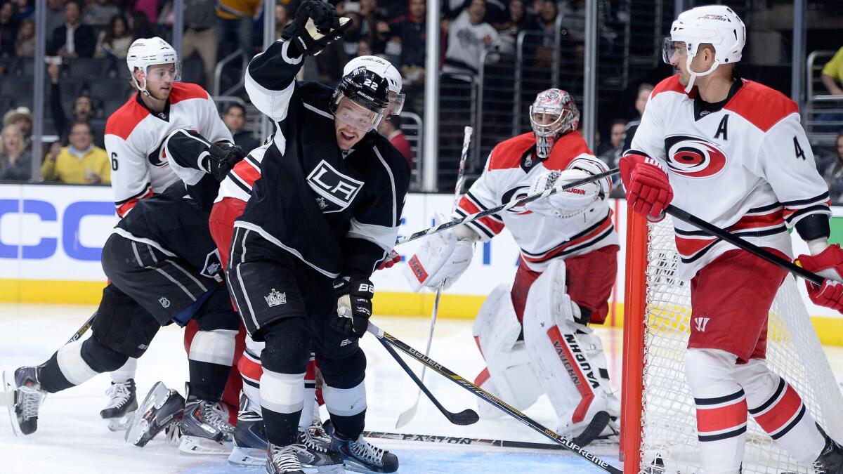 Kings forward Trevor Lewis, center, celebrates after scoring in front of Carolina Hurricanes goalie Cam Ward, second right, and defenseman Andrej Sekera, right, during the second period of the Kings' 3-2 win at Staples Center on Thursday.
