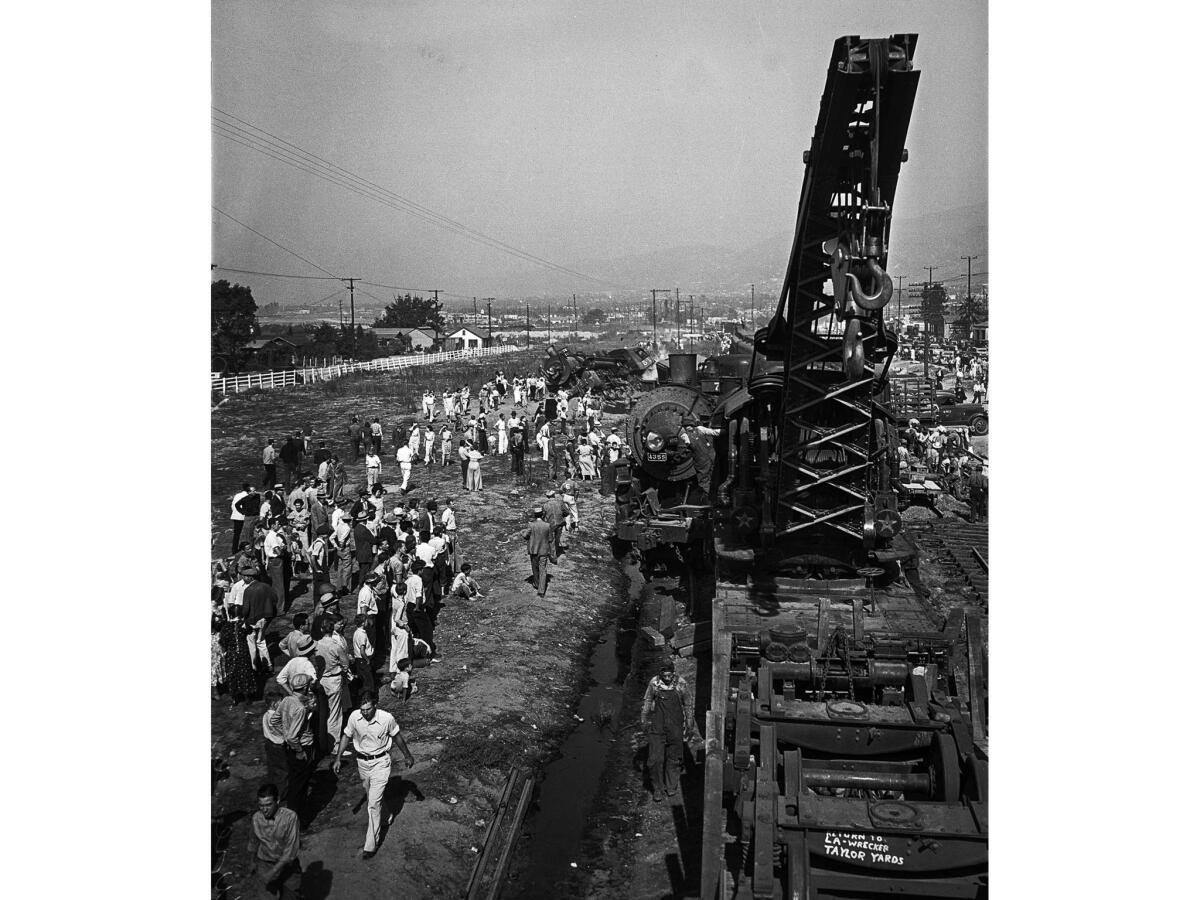 Oct. 19, 1935: Crowds gather as a crane begins clearing wreckage from the train accident.