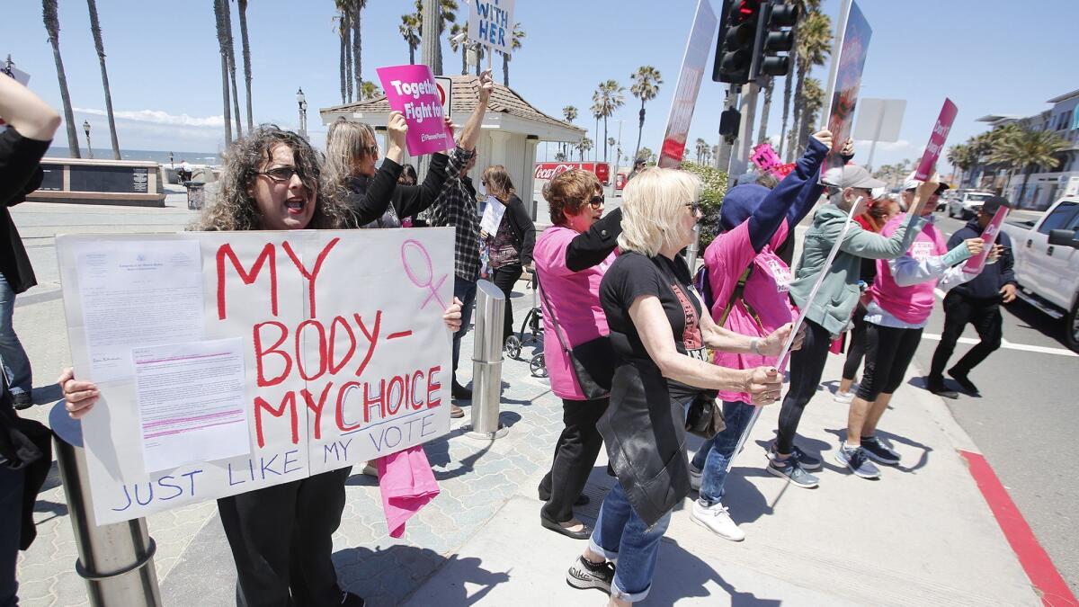 Tuesday’s demonstration in Huntington Beach, called “Stop the Bans,” joined others planned around the country on the heels of Alabama’s near-total abortion ban and partial bans in other states.