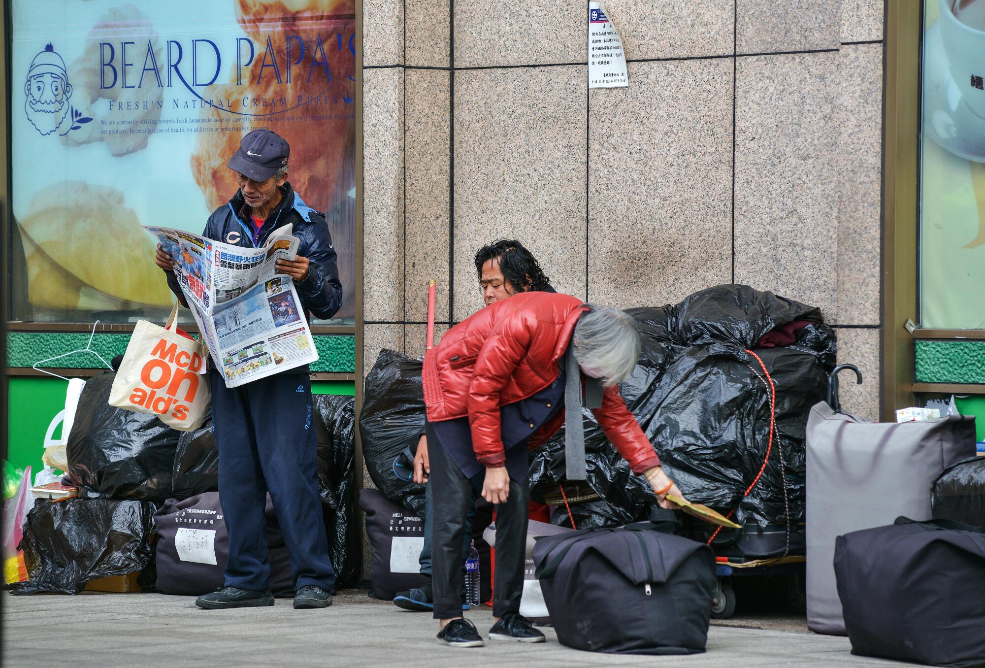 Homeless Taiwanese pass the day on the south side of Taipei's main rail station.