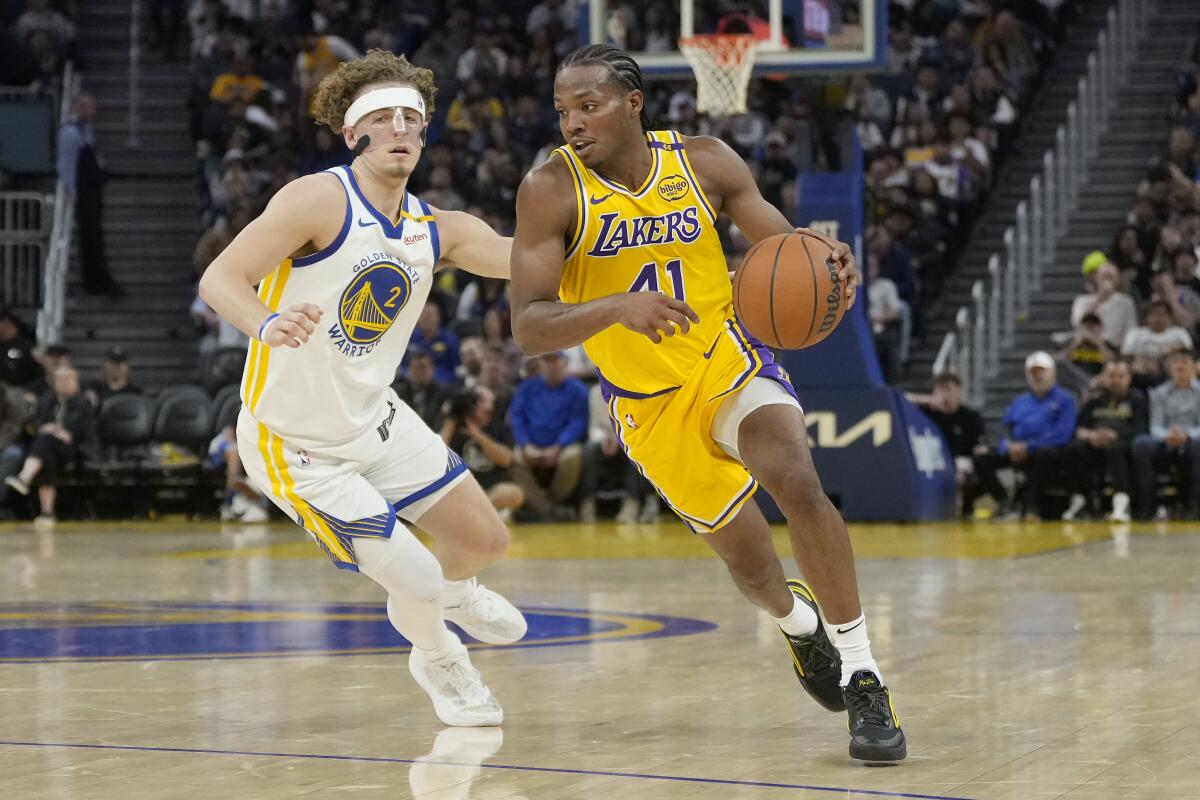 Lakers guard Quincy Olivari (41) drives to the basket against Warriors guard Brandin Podziemski on Friday.