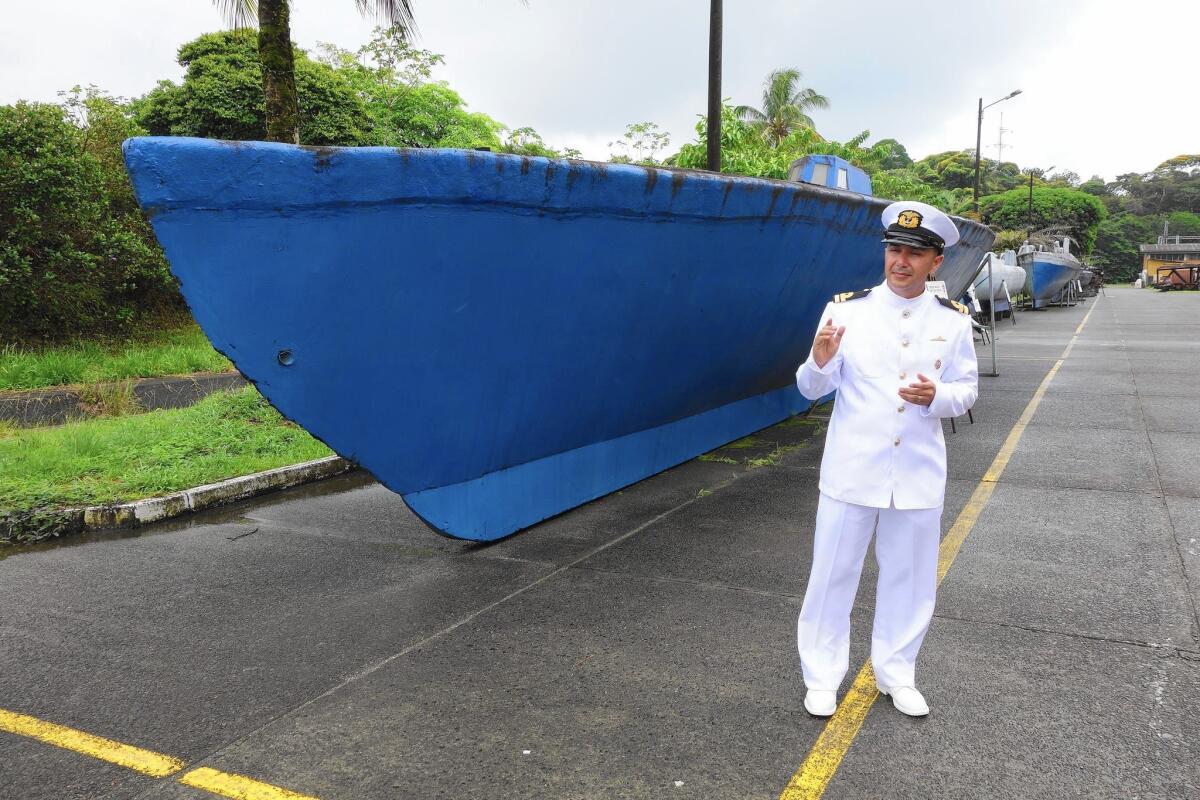 Colombian navy Lt. Cmdr. Rodrigo Pedraza with a 100-foot-long submarine intended for use in smuggling cocaine, one of several narco-vessels on display at a naval base near Buenaventura.