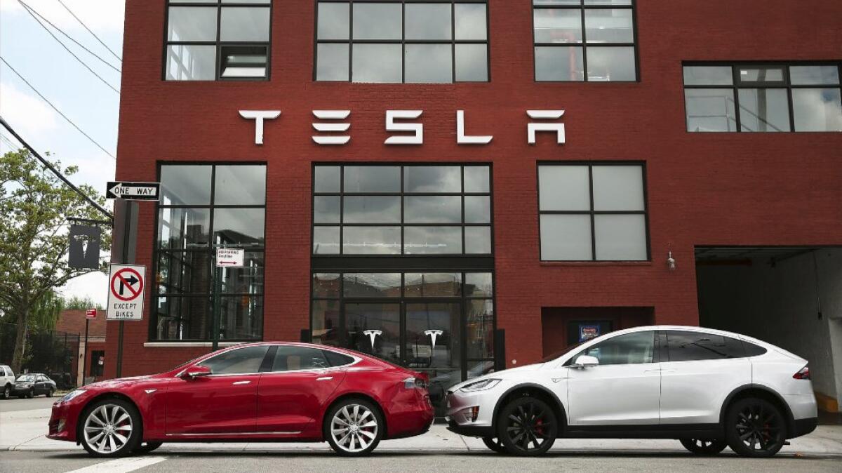 Tesla Motors vehicles sit parked outside a new Tesla showroom and service center in Brooklyn, N.Y.'s Red Hook neighborhood July 5.