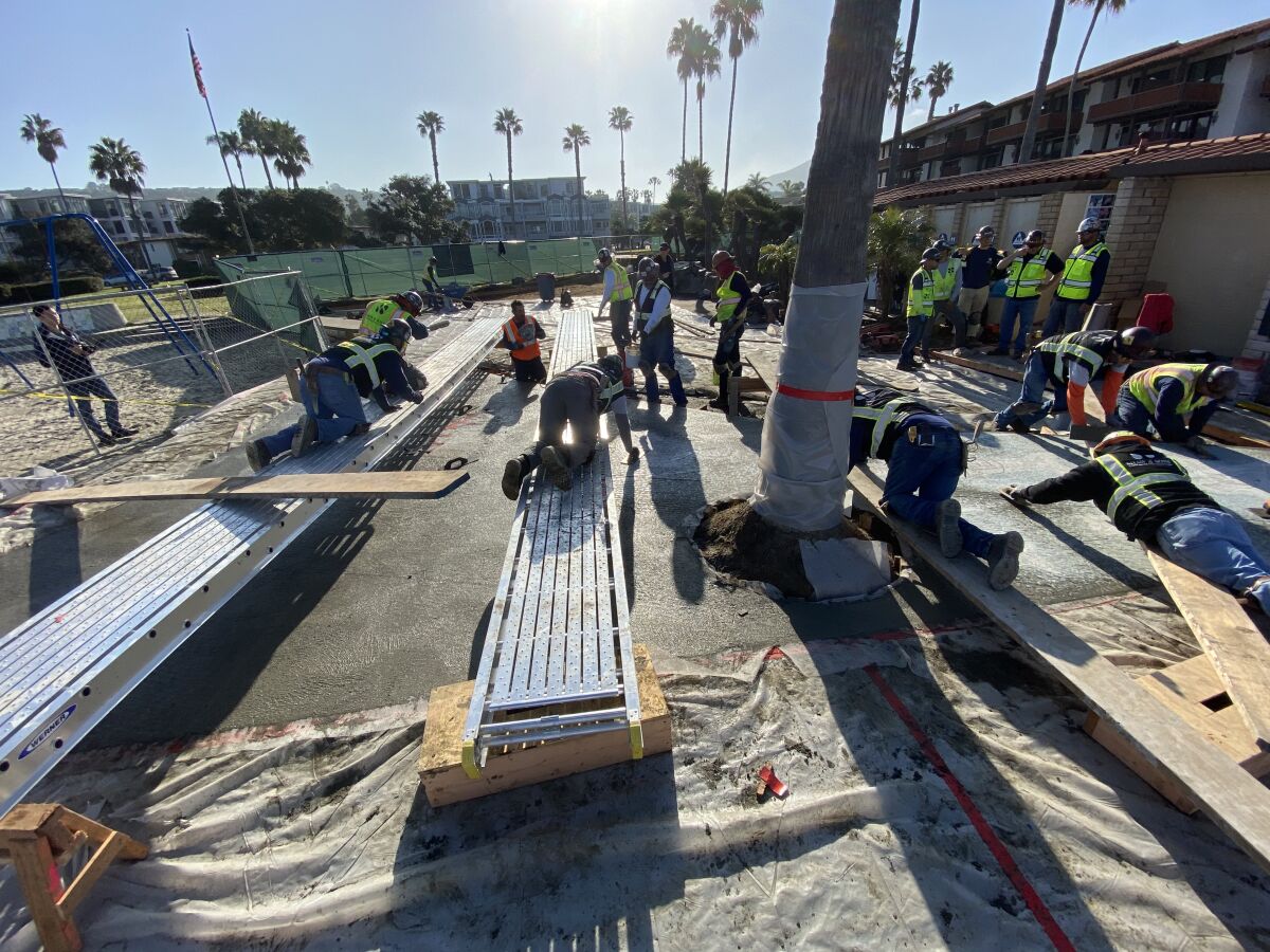 Workers from Shaw & Sons Conrete pour and pave thousands of pounds of concrete for The Map of the Grand Canyons of La Jolla Educational Plaza in Kellogg Park, February 2020.