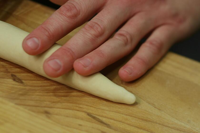 Form each ball of dough into a "rope" 8 to 10 inches long and tapered at the end.