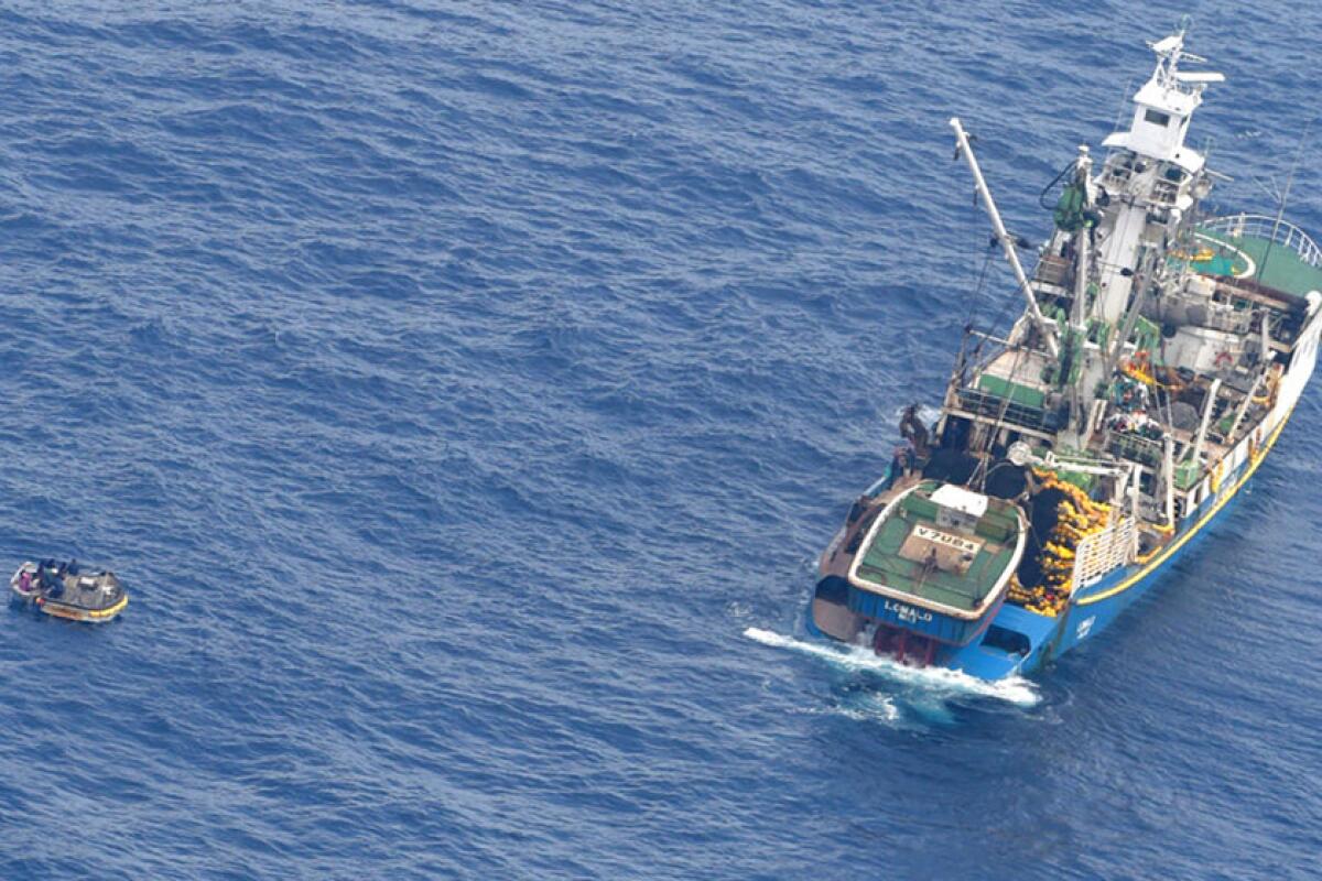 Seven survivors were rescued from a small wooden dinghy, left, after a ferry sank near the Pacific nation of Kiribati on Jan. 18, 2018.