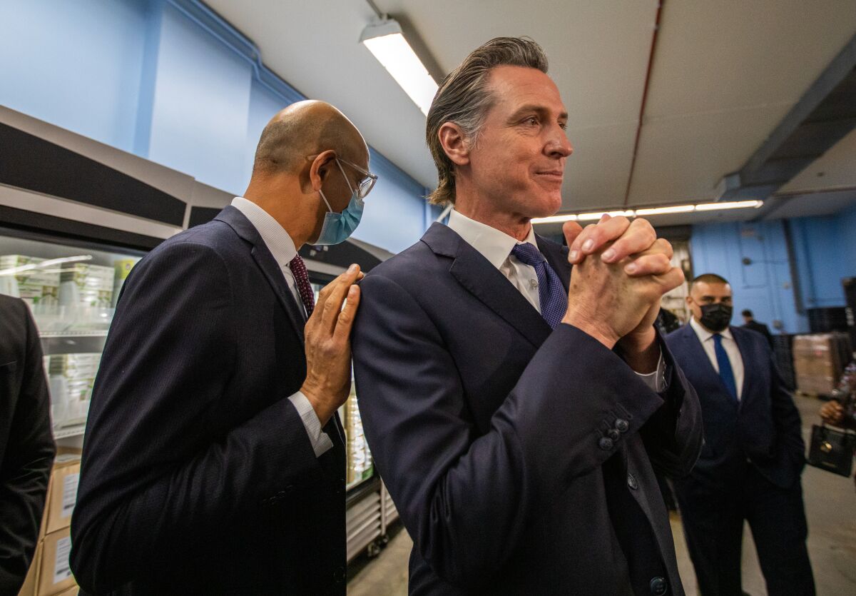 Mark Ghaly, left,  with Gov.  Newsom