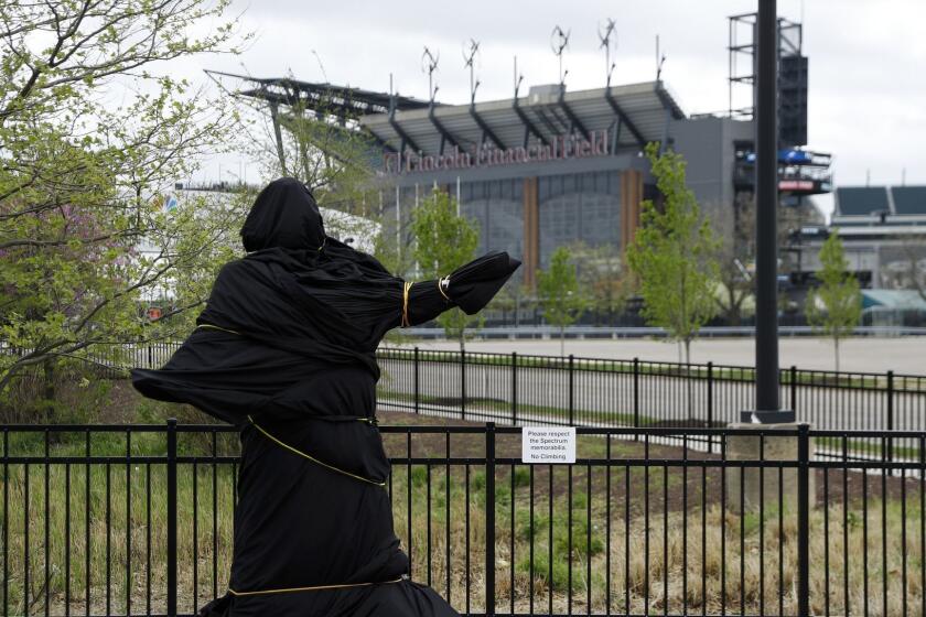 A covered statue of singer Kate Smith is seen near the Wells Fargo Center, Friday, April 19, 2019, in Philadelphia. The Philadelphia Flyers covered the statue of singer Kate Smith outside their arena, following the New York Yankees in cutting ties and looking into allegations of racism against the 1930s star with a popular recording of "God Bless America." (AP Photo/Matt Slocum)
