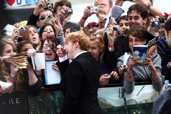 Rupert Grint signs autographs for fans at the premiere of 'Harry Potter and the Deathly Hallows: Part 2'