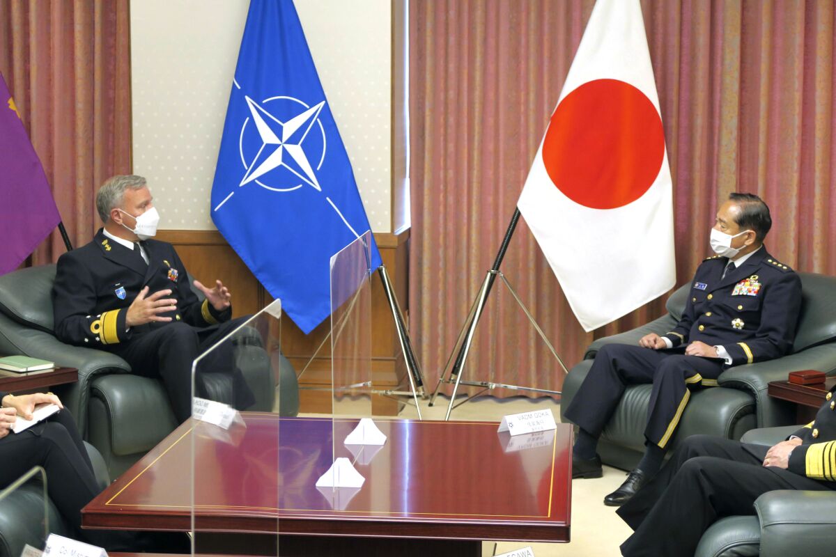 NATO Military Committee chief Rob Bauer, left, meets with Japanese Chief of Staff Koji Yamazaki, right, at the defense ministry in Tokyo, Tuesday, June 7, 2022. Japanese and NATO officials on Tuesday agreed to step up their military cooperation and joint exercises in each other’s regions as the two sides as they share concern that Russia’s invasion of Ukraine is deteriorating the security environment in Europe and Asia.(Kyodo News via AP)