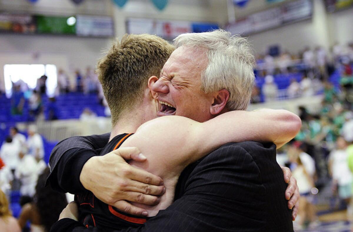 Jakob Gollon hugs Mercer Coach Bob Hoffman after the team clinched a berth in the NCAA tournament.