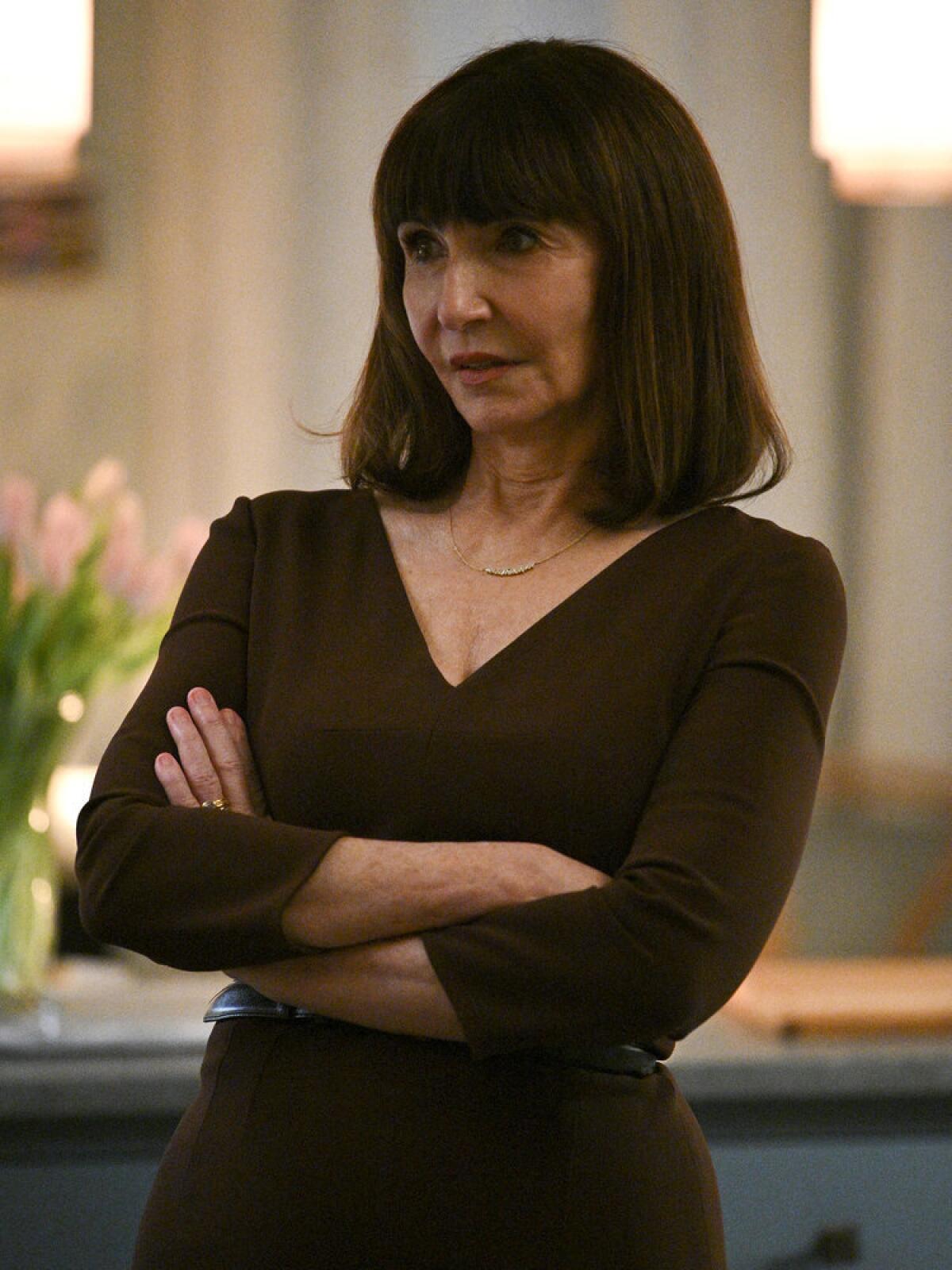 Mary Steenburgen in a brown V-neck with her arms crossed