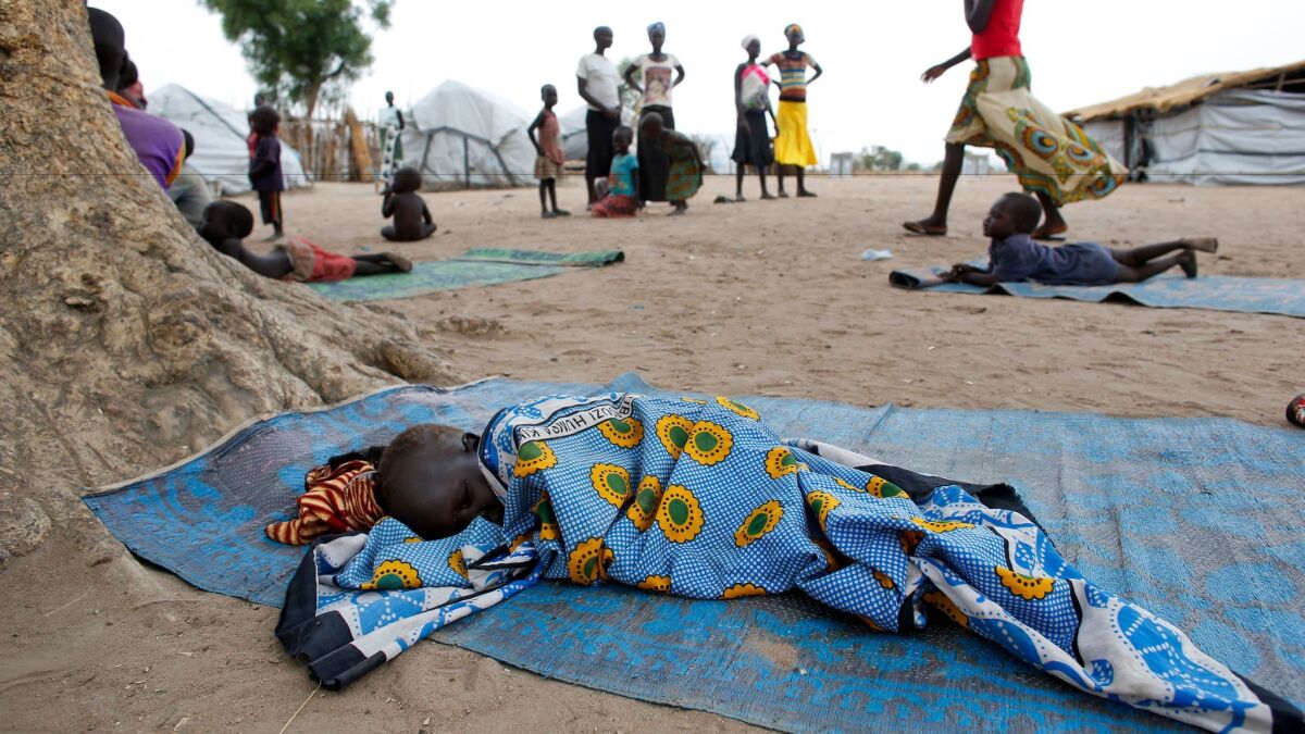 A child sleeps on a mat at a camp for those who were previously displaced by fighting, in Gumbo, South Sudan. (Matthieu Alexandre / Associated Press)
