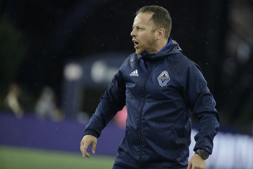 Vancouver Whitecaps head coach Marc Dos Santos shouts from the bench during the first half of an MLS soccer match against the New England Revolution, Wednesday, July 17, 2019, in Foxborough, Mass. The Revolution won 4-0. (AP Photo/Steven Senne)