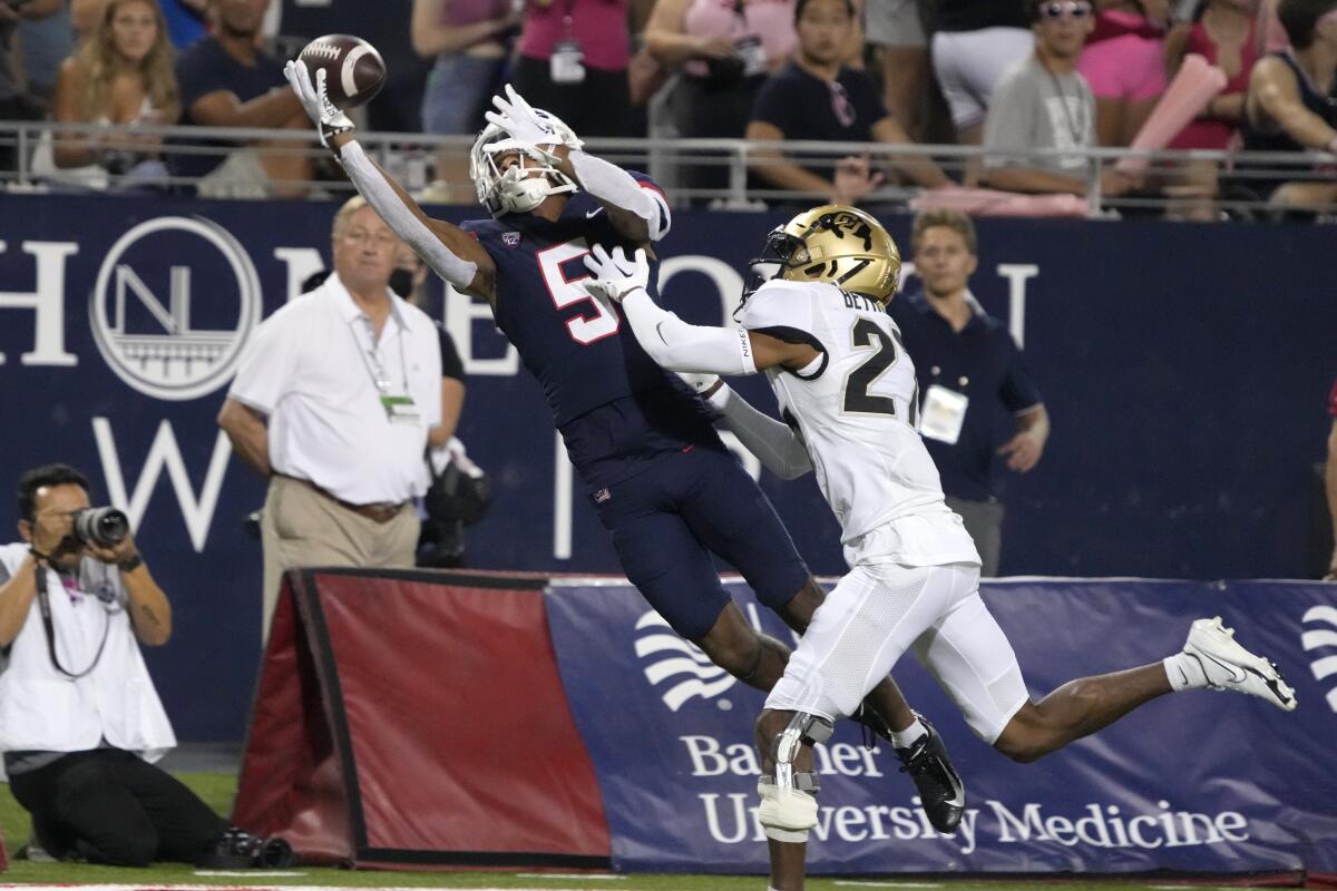 Arizona wide receiver Dorian Singer (5) makes a catch while being defended by Colorado cornerback Nigel Bethel Jr. 