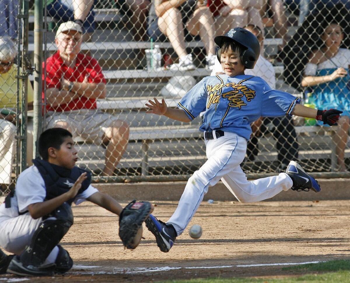 Crescenta Valley's Jason Kim strides safely into home in a 25-8 win over Tujunga.