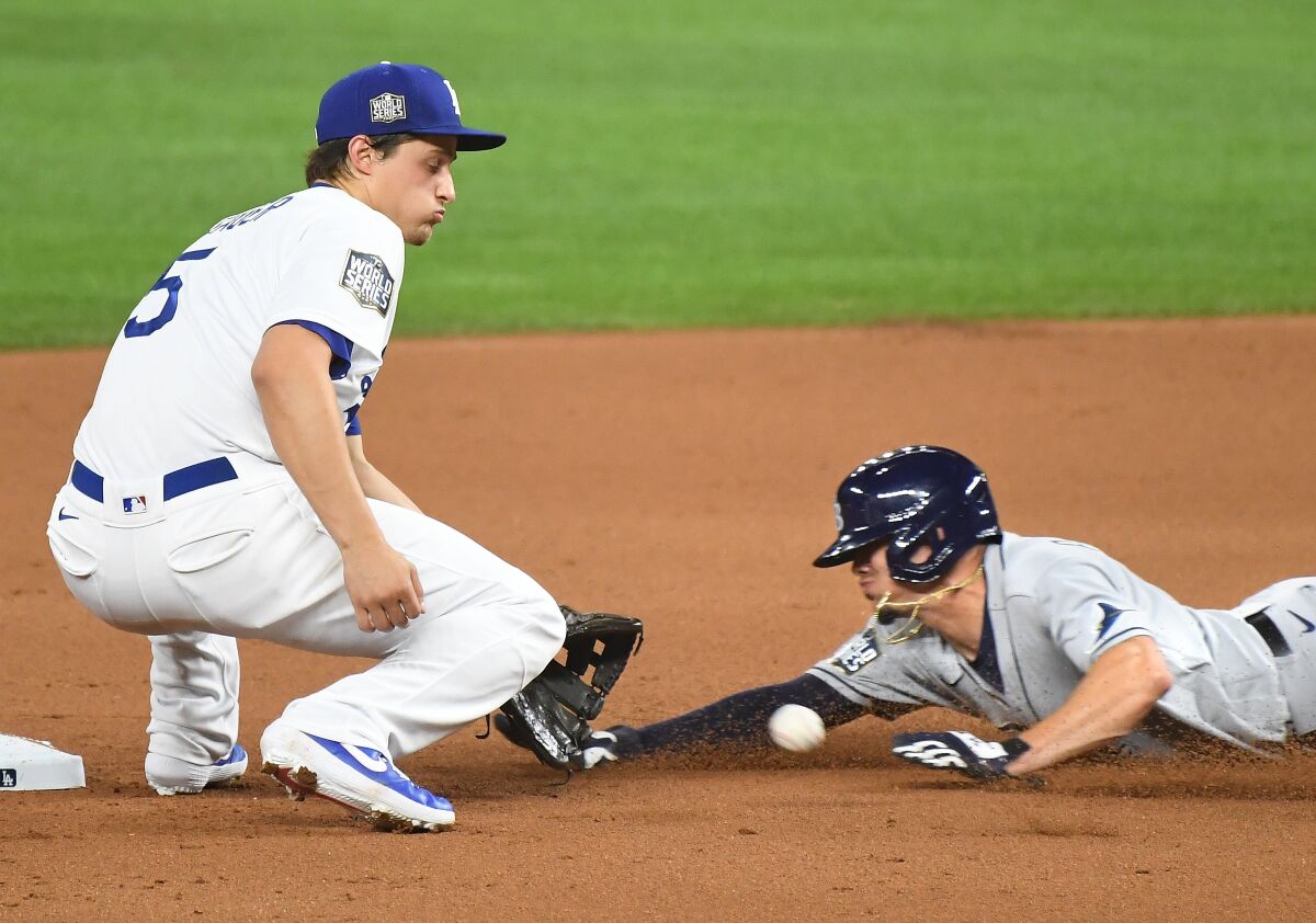 Dodgers shortstop Corey Seager tags out Rays baserunner Willy Adames at second base during the second inning.