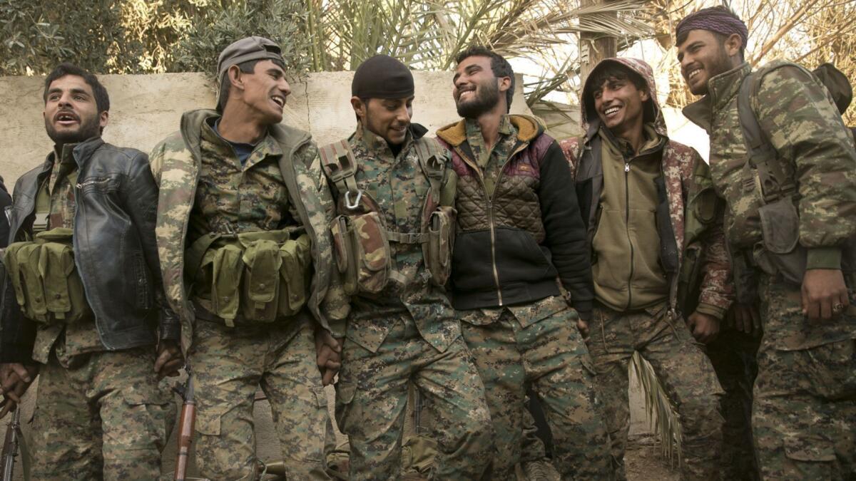 U.S.-backed Syrian Democratic Forces fighters celebrate their territorial gains over Islamic State militants in Baghouz, Syria on Tuesday.
