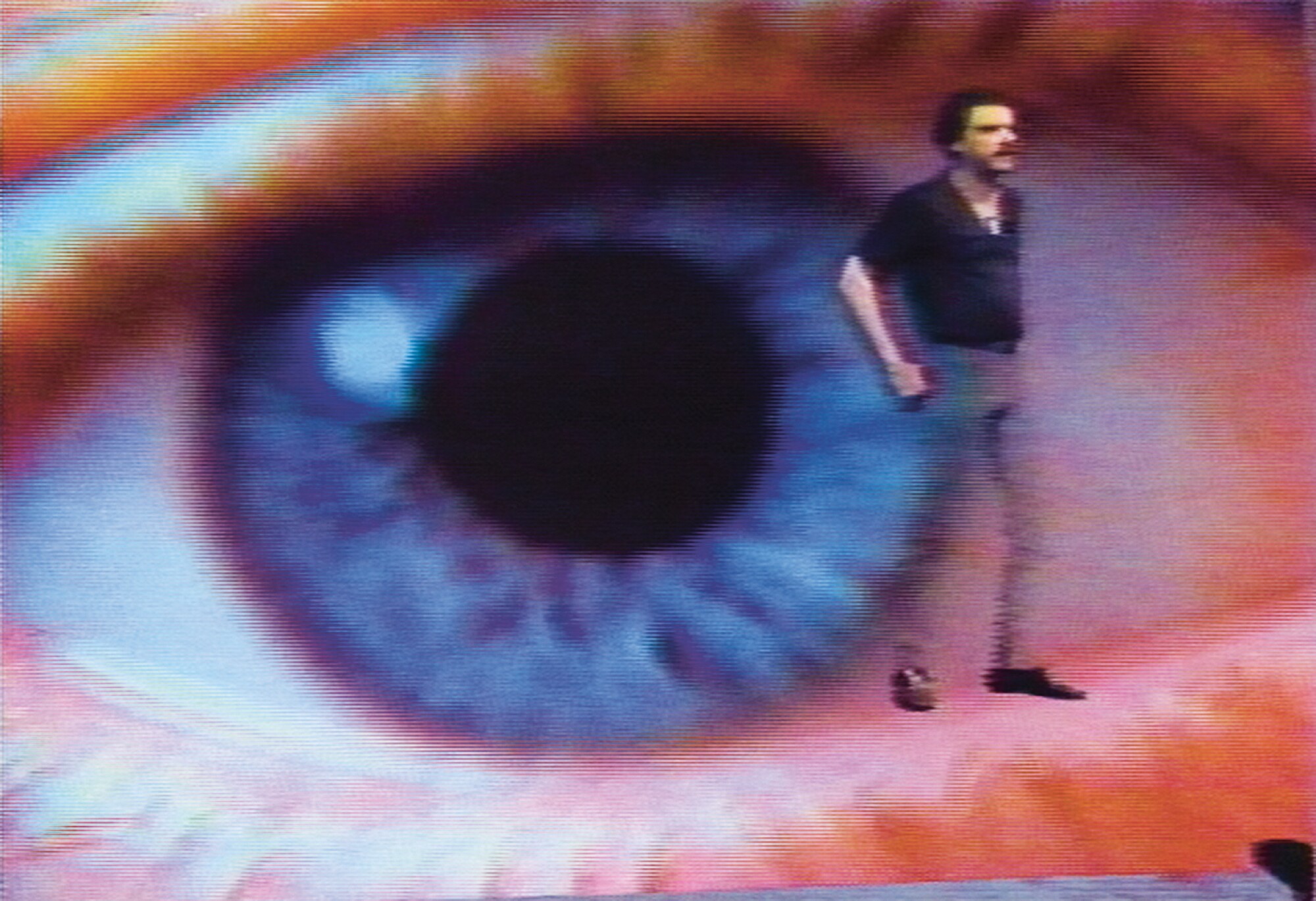 Media scholar Gene Youngblood is seen superimposed over a giant eyeball.