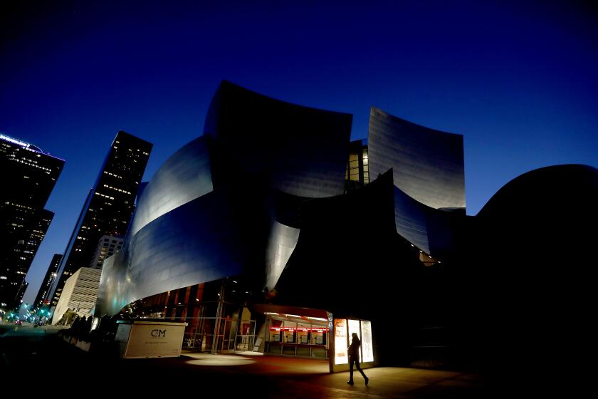 LOS ANGELES CALIF. -MAR. 18, 2020. The Walt Disney Concert Hall is dark on Wednesday night, Mar. 18, 2020. The popular entertainment venue has temporarily shut down as a safety precaution against the spread of coronavirus. (Luis Sinco/Los Angeles Times)