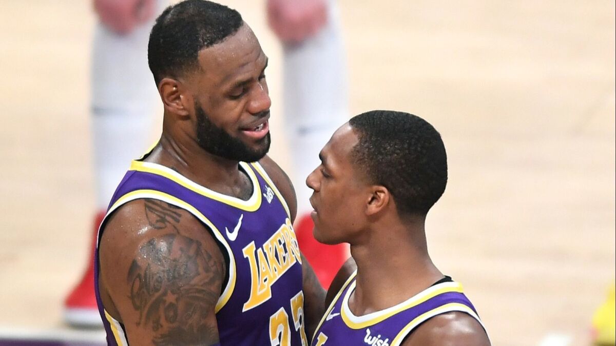 Lakers' LeBron James, left, is congratulated by Rajon Rondo after his basket against the Denver Nuggets passing Michael Jordan on the all-time scoring list on Wednesday at Staples Center.